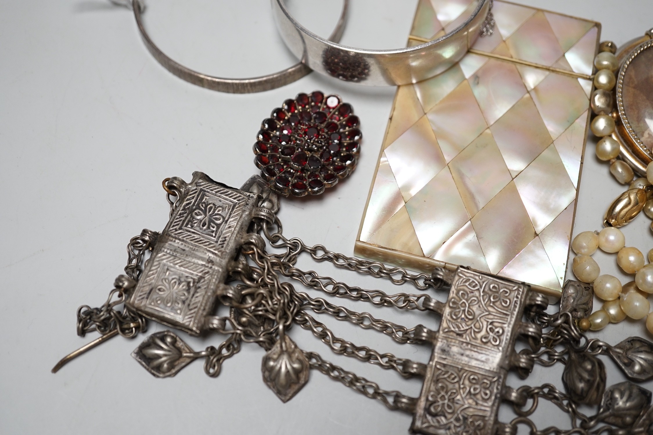 A collection of Victorian and later costume jewellery and a mother of pearl card case.